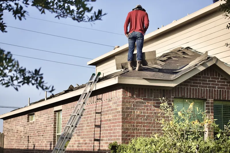 Professional roofer working on a residential roof in Taylorsville East